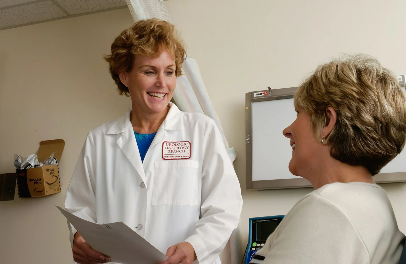 A clinician speaking with a patient during a medical consultation