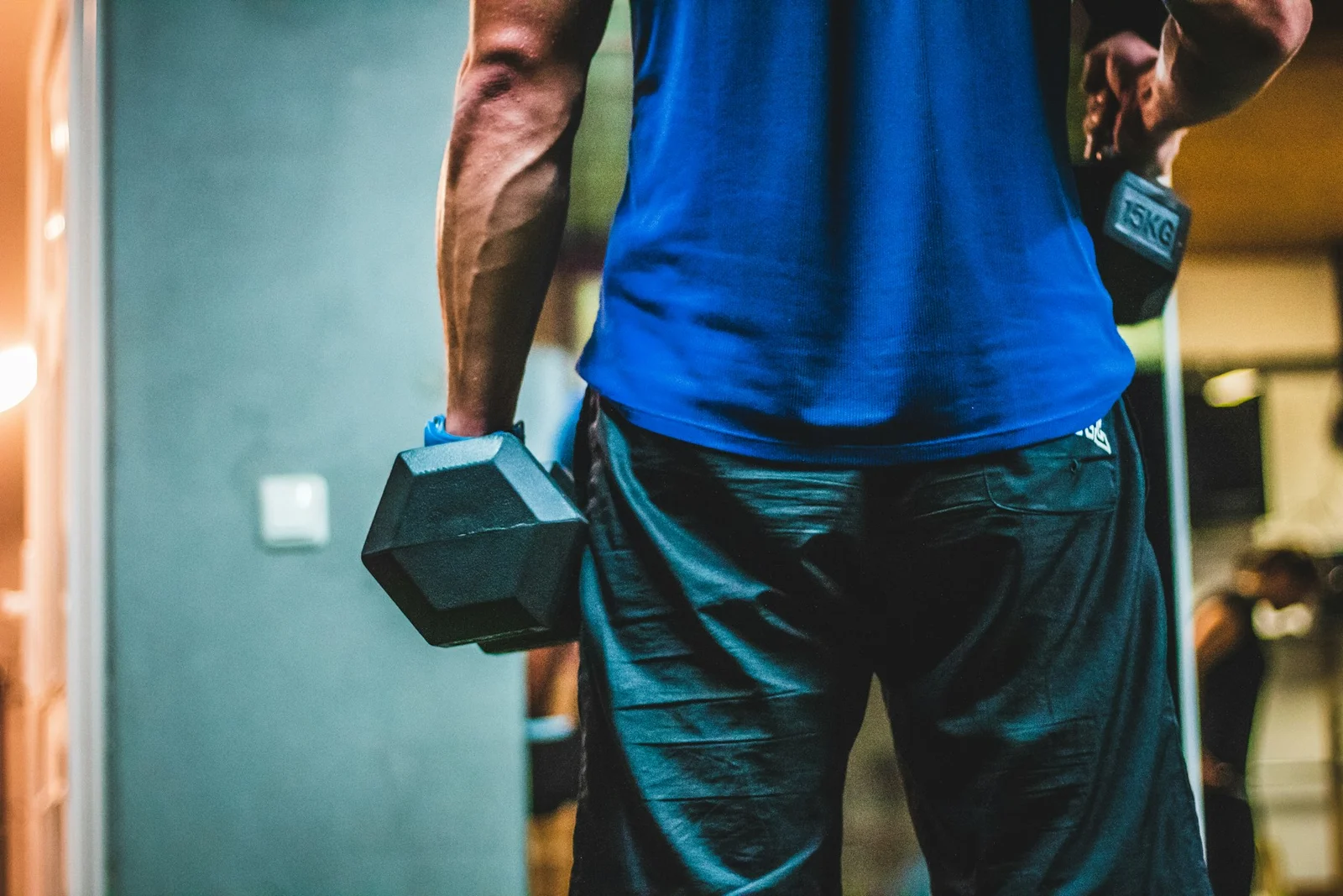 A person holding dumbbells during a strength-training session